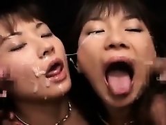 Two trashy Oriental babes getting their faces covered in fr